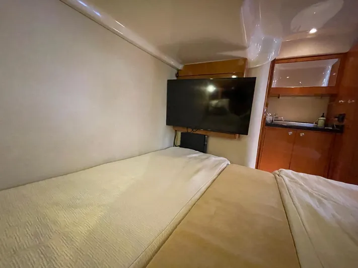  Yacht Photos Pics Interior of 2010 Regal 44 Sport Coupe with bed, TV, and kitchenette.