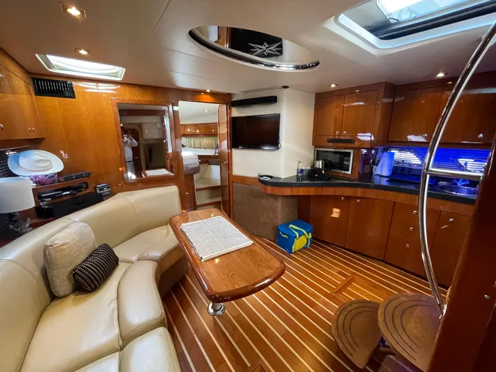  Yacht Photos Pics Luxurious interior of 2010 Regal 44 Sport Coupe yacht with elegant wood finishes.
