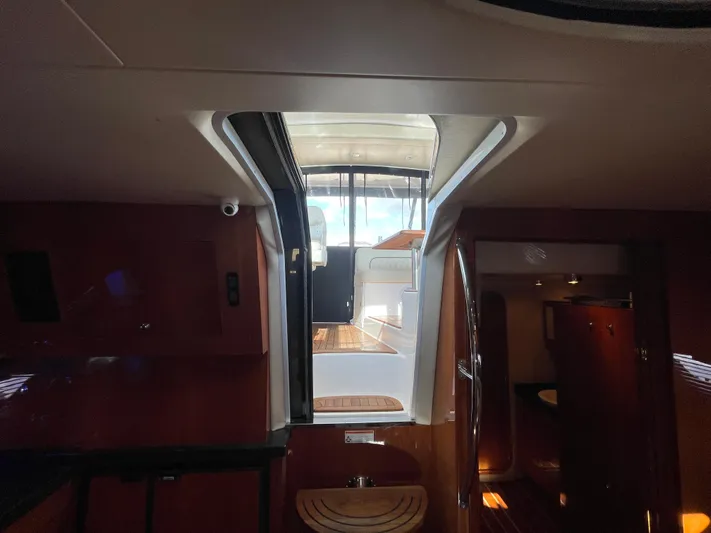  Yacht Photos Pics Interior view of a 2010 Regal 44 Sport Coupe yacht, showcasing elegant wood finishes.