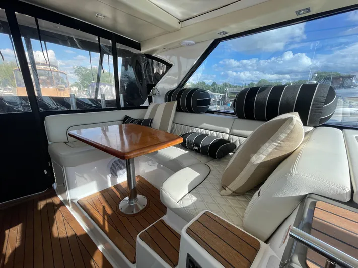  Yacht Photos Pics Luxurious interior of 2010 Regal 44 Sport Coupe with plush seating and wooden table.