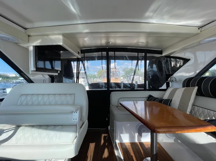  Yacht Photos Pics Interior of 2010 Regal 44 Sport Coupe yacht with elegant seating and wooden table.