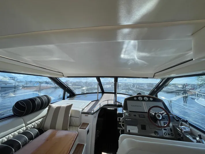  Yacht Photos Pics Interior view of 2010 Regal 44 Sport Coupe yacht with modern helm and seating.