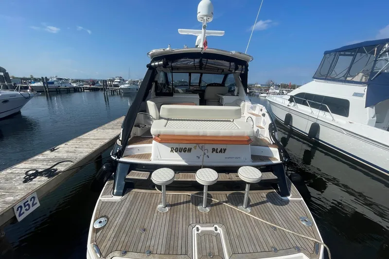  Yacht Photos Pics 2010 Regal 44 Sport Coupe docked at marina, rear view with seating and water backdrop.