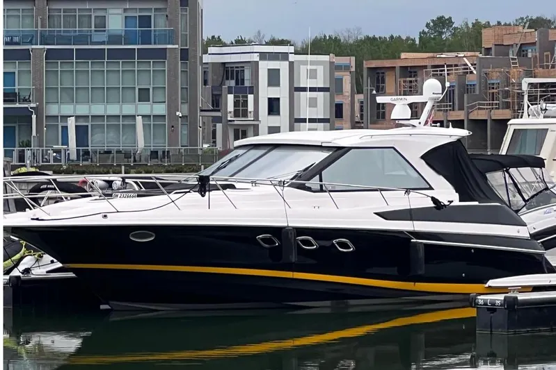  Yacht Photos Pics 2010 Regal 44 Sport Coupe yacht docked at a modern marina.