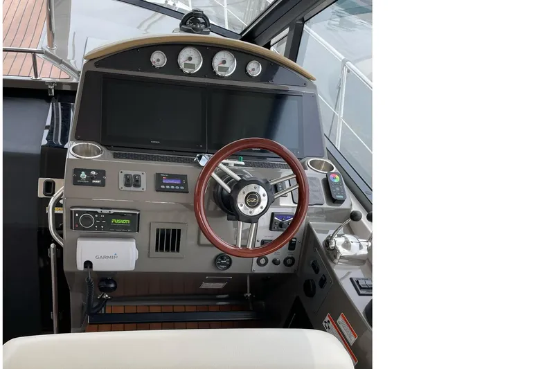  Yacht Photos Pics Cockpit of 2010 Regal 44 Sport Coupe with steering wheel and navigation controls.