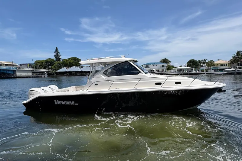 Lieuanna Yacht Photos Pics 2024 Pursuit OS 355 Offshore boat on calm water, side view.