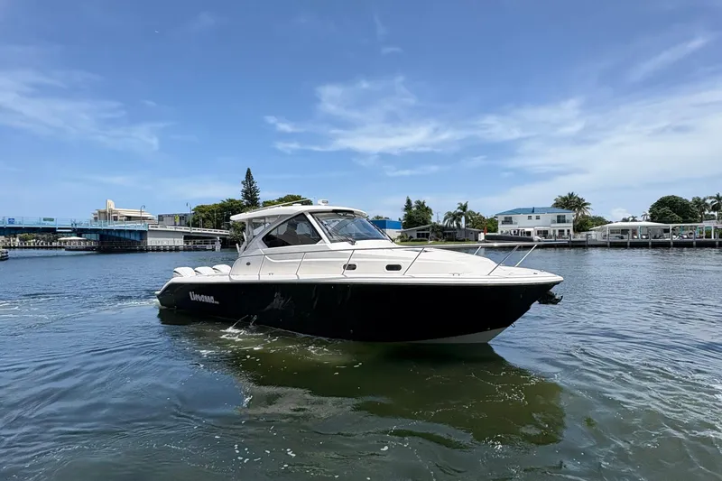 Lieuanna Yacht Photos Pics 2024 Pursuit OS 355 Offshore boat cruising on a sunny day in a coastal area.