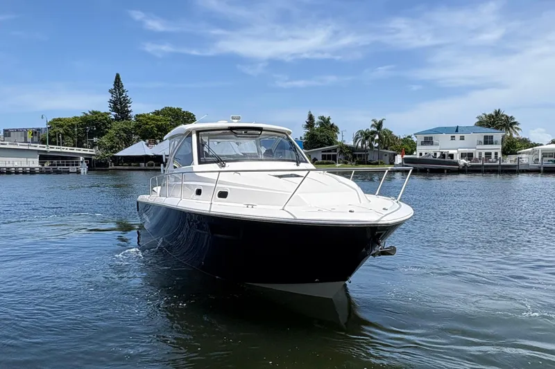 Lieuanna Yacht Photos Pics 2024 Pursuit OS 355 Offshore boat cruising on a sunny day in a waterfront setting.
