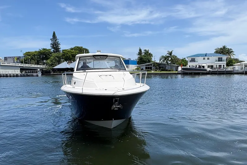 Lieuanna Yacht Photos Pics 2024 Pursuit OS 355 Offshore boat on calm water near residential area.