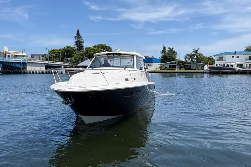 Lieuanna Yacht Photos Pics 2024 Pursuit OS 355 Offshore boat cruising on a calm waterway.