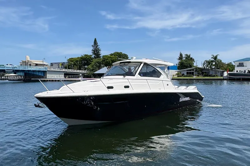 Lieuanna Yacht Photos Pics 2024 Pursuit OS 355 Offshore boat on calm water, under a clear blue sky.