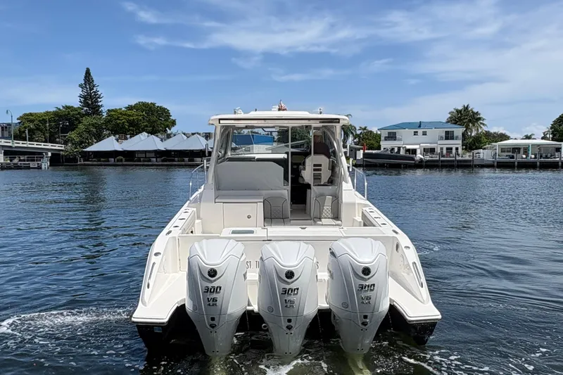 Lieuanna Yacht Photos Pics 2024 Pursuit OS 355 Offshore boat with triple 300 V6 engines on a calm waterway.