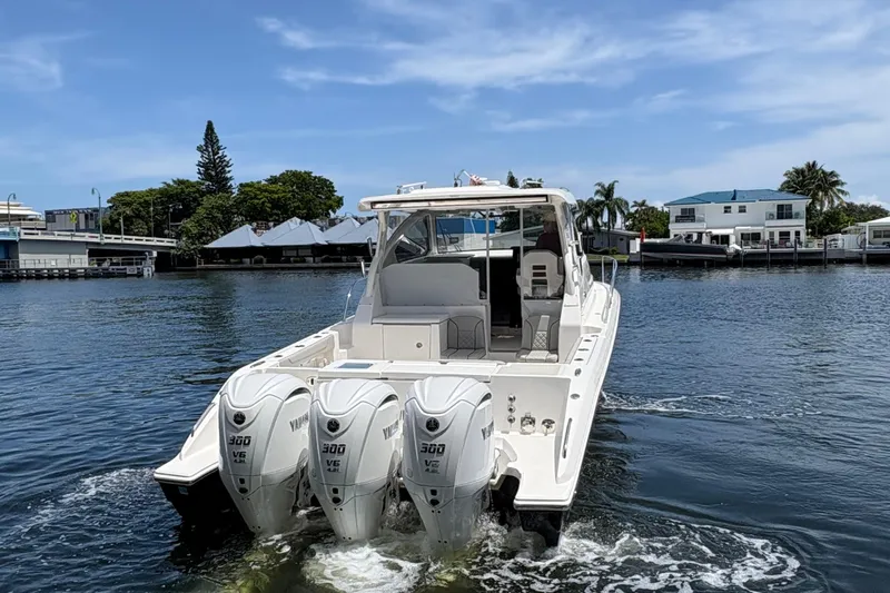 Lieuanna Yacht Photos Pics 2024 Pursuit OS 355 Offshore boat with triple Yamaha engines on a calm waterway.
