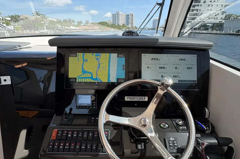 Lieuanna Yacht Photos Pics 2024 Pursuit OS 355 Offshore helm with navigation screens and steering wheel.