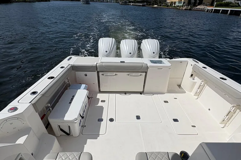 Lieuanna Yacht Photos Pics 2024 Pursuit OS 355 Offshore boat with triple engines on a calm waterway.