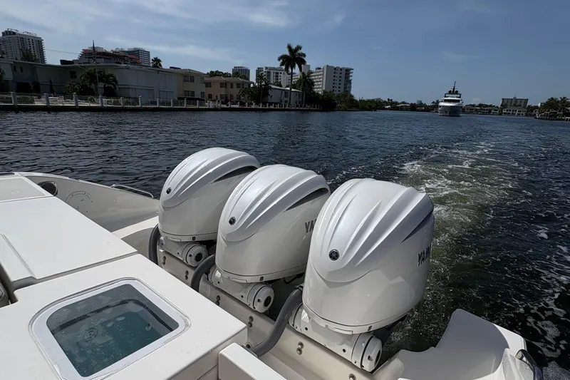 Lieuanna Yacht Photos Pics 2024 Pursuit OS 355 Offshore boat with triple Yamaha outboard engines on a sunny waterway.