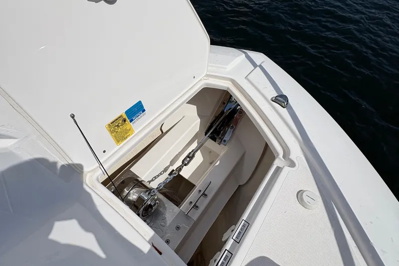 Lieuanna Yacht Photos Pics 2024 Pursuit OS 355 Offshore anchor locker with chain and winch, open on calm water.