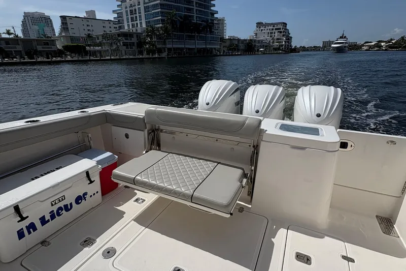 Lieuanna Yacht Photos Pics 2024 Pursuit OS 355 Offshore boat with triple engines, spacious deck, and waterfront view.