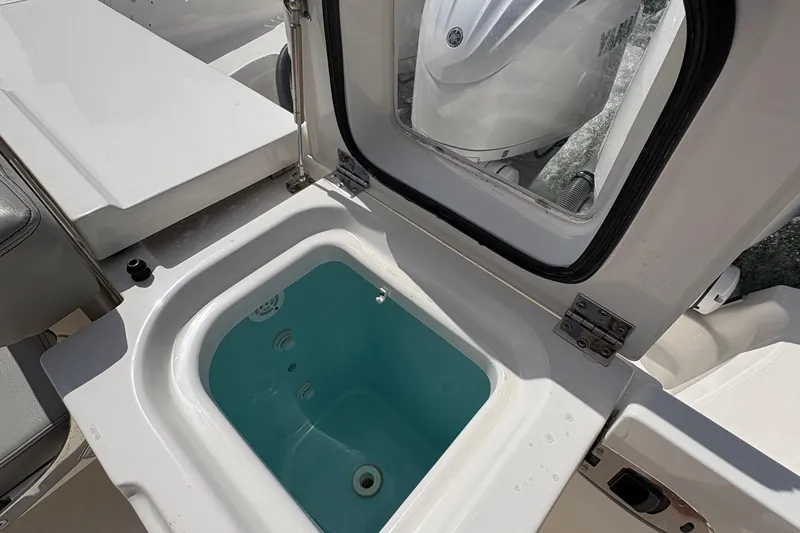 Lieuanna Yacht Photos Pics 2024 Pursuit OS 355 Offshore boat with open storage compartment and visible engine.