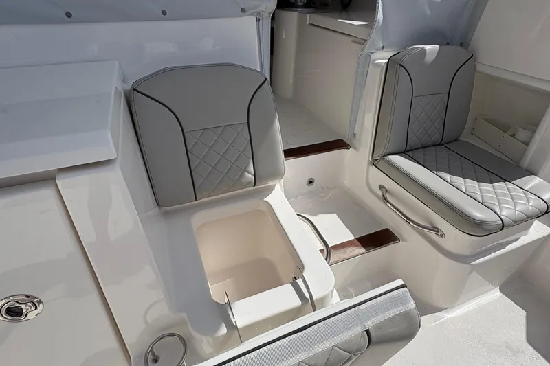 Lieuanna Yacht Photos Pics 2024 Pursuit OS 355 Offshore boat interior with cushioned seating and storage compartments.
