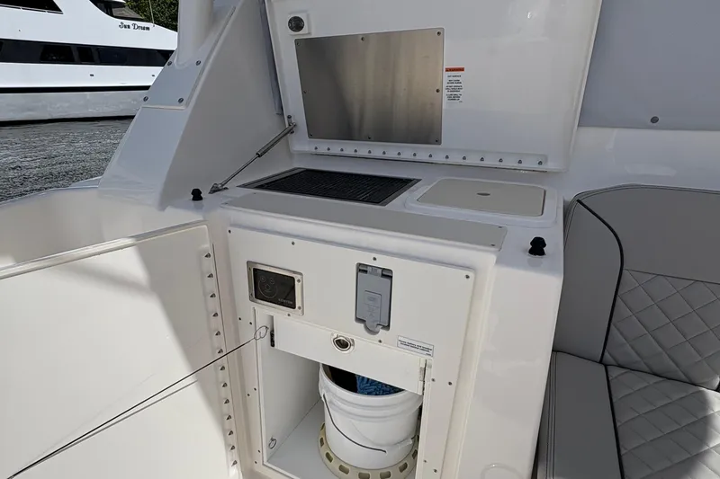 Lieuanna Yacht Photos Pics 2024 Pursuit OS 355 Offshore boat interior with kitchenette and seating area.