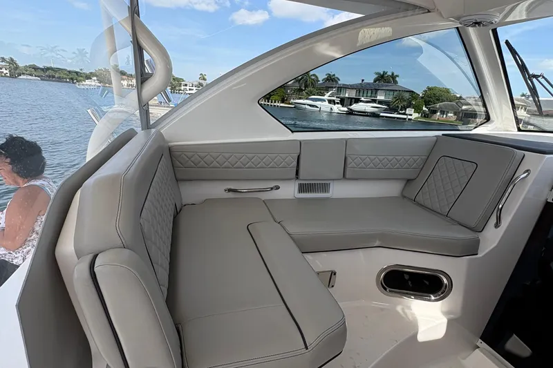Lieuanna Yacht Photos Pics 2024 Pursuit OS 355 Offshore boat interior with luxurious seating and waterfront view.