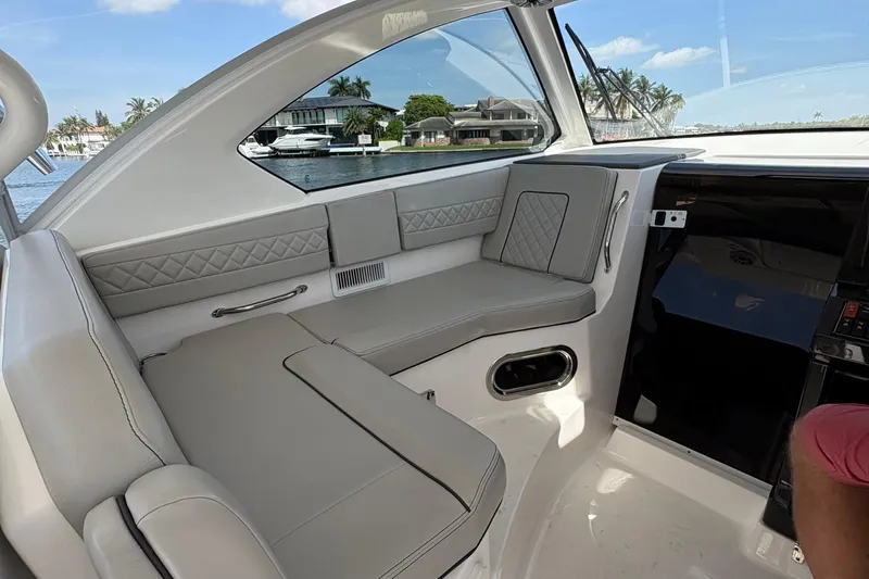 Lieuanna Yacht Photos Pics 2024 Pursuit OS 355 Offshore boat interior with luxurious seating and waterfront view.