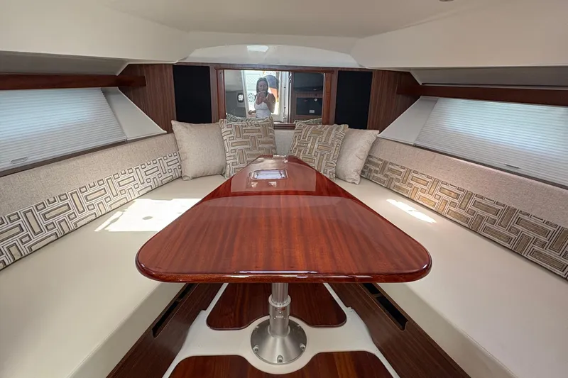 Lieuanna Yacht Photos Pics Interior of 2024 Pursuit OS 355 Offshore boat with elegant seating and wooden table.