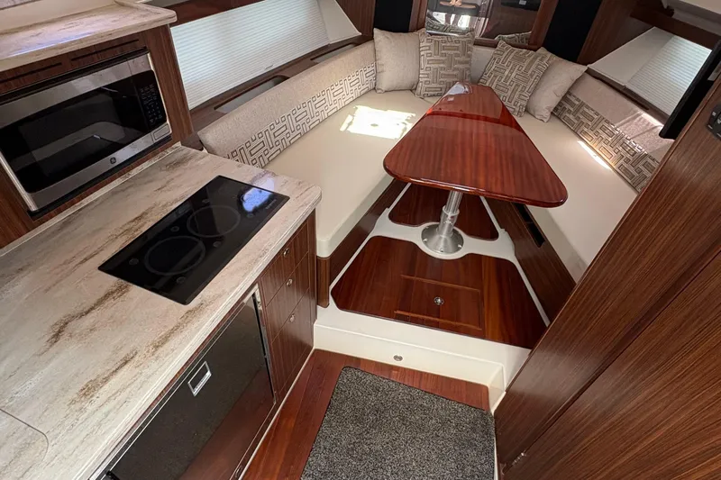 Lieuanna Yacht Photos Pics 2024 Pursuit OS 355 Offshore interior with modern kitchen and cozy seating area.