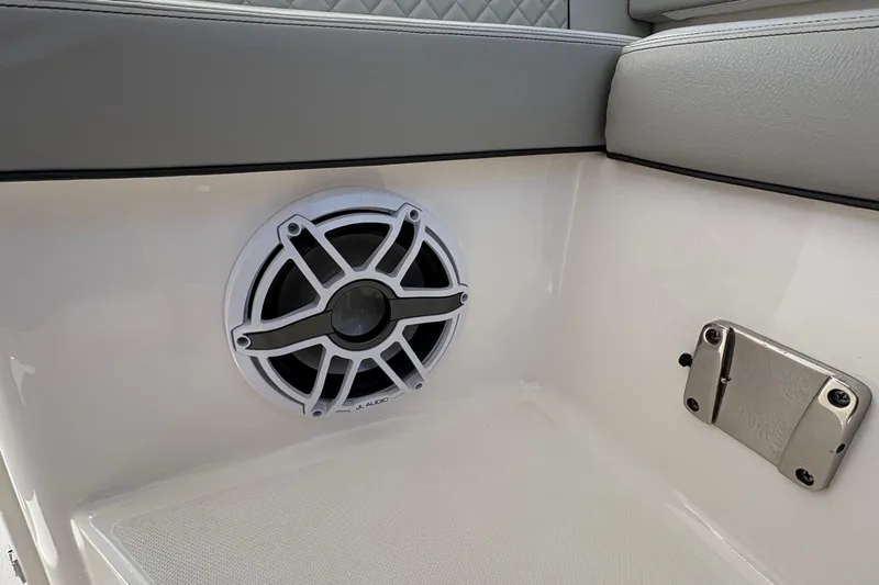 Lieuanna Yacht Photos Pics 2024 Pursuit OS 355 Offshore boat interior with JL Audio speaker and cushioned seating.