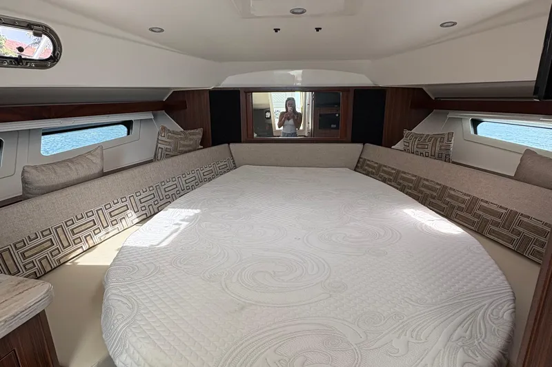 Lieuanna Yacht Photos Pics 2024 Pursuit OS 355 Offshore cabin interior with round bed and elegant decor.