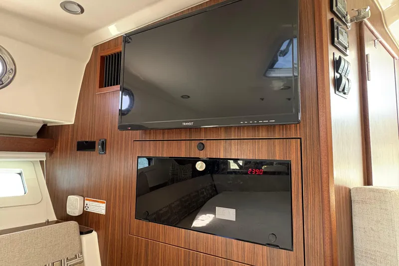 Lieuanna Yacht Photos Pics 2024 Pursuit OS 355 Offshore interior with mounted TV and control panel.