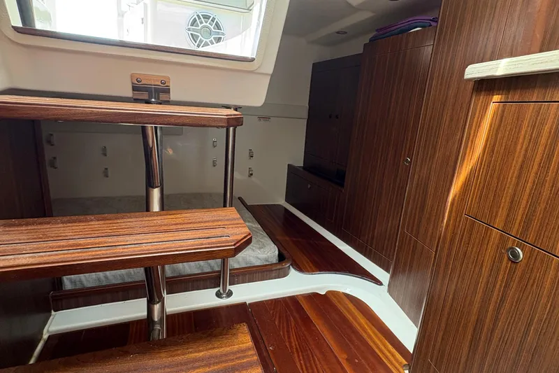 Lieuanna Yacht Photos Pics 2024 Pursuit OS 355 Offshore cabin interior with wooden stairs and cabinetry.