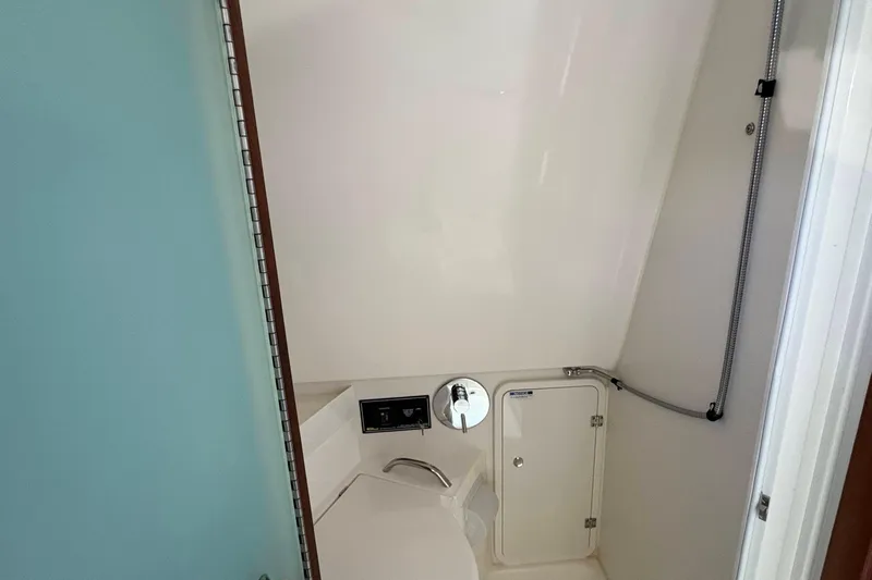 Lieuanna Yacht Photos Pics 2024 Pursuit OS 355 Offshore bathroom with shower and storage compartment.