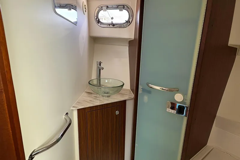 Lieuanna Yacht Photos Pics 2024 Pursuit OS 355 Offshore bathroom with glass sink and modern fixtures.