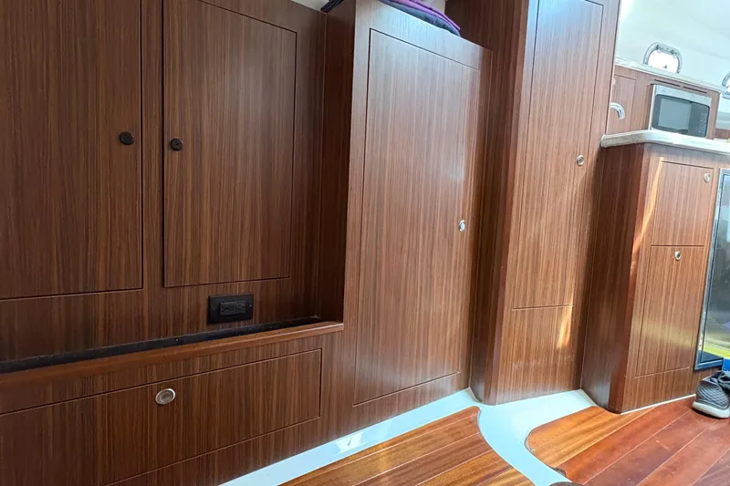 Lieuanna Yacht Photos Pics 2024 Pursuit OS 355 Offshore interior with wooden cabinetry and modern appliances.