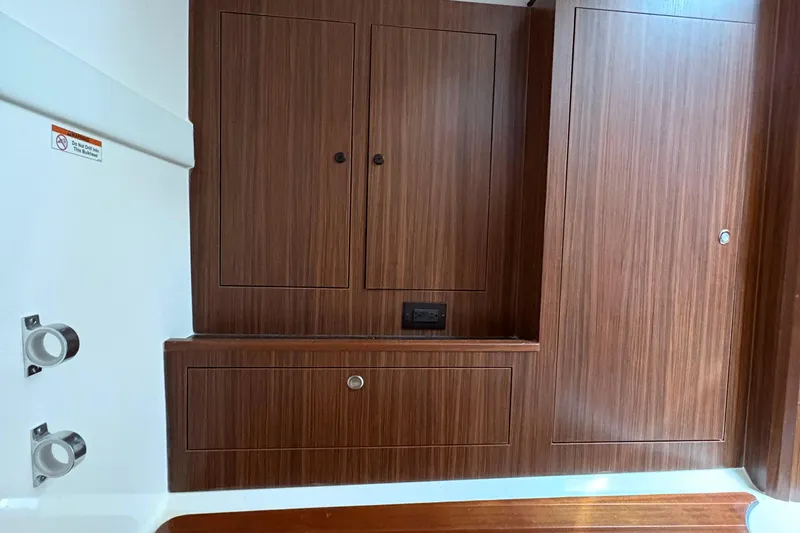 Lieuanna Yacht Photos Pics 2024 Pursuit OS 355 Offshore interior with sleek wooden cabinetry and modern design.