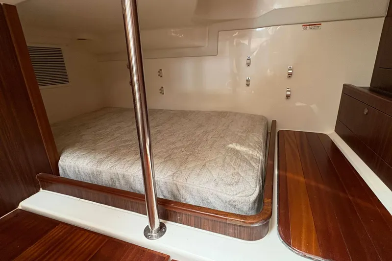 Lieuanna Yacht Photos Pics 2024 Pursuit OS 355 Offshore cabin interior with bed and wooden accents.