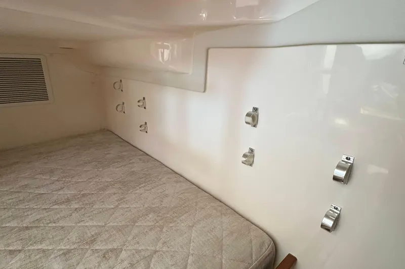 Lieuanna Yacht Photos Pics 2024 Pursuit OS 355 Offshore cabin interior with mattress and wall hooks.