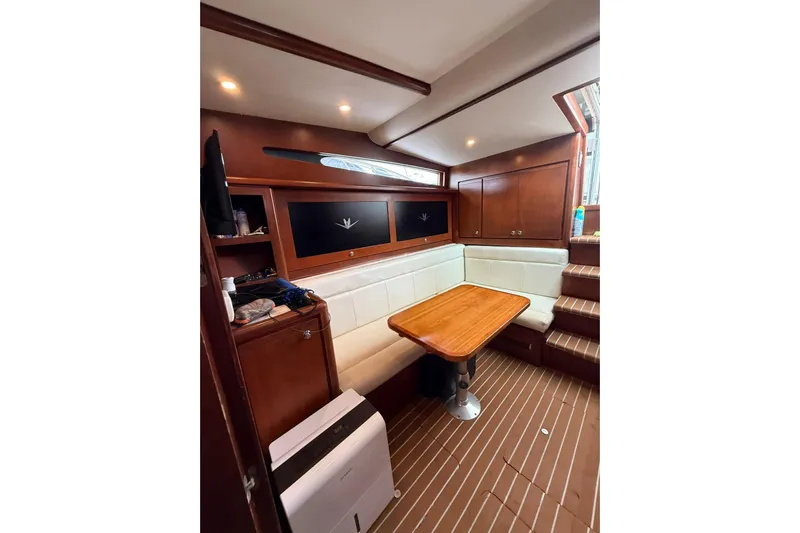  Yacht Photos Pics Luxurious interior of 2009 Bertram 390 yacht with wooden table and white seating.