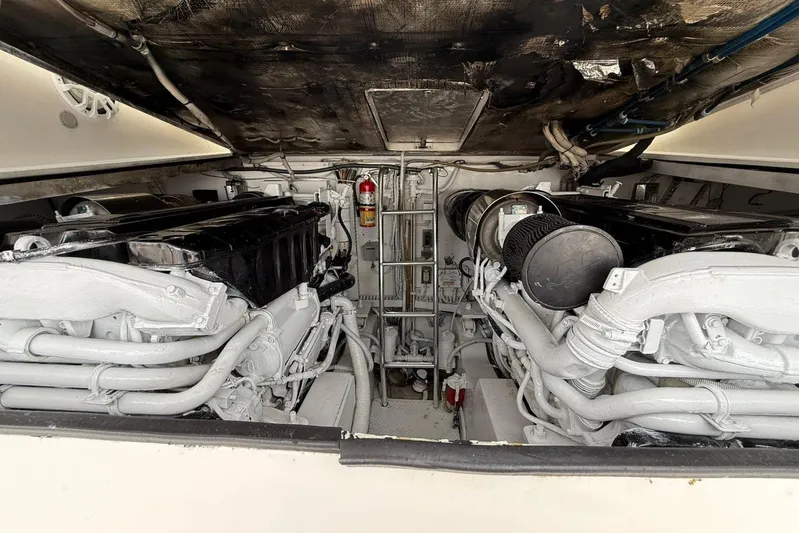  Yacht Photos Pics Engine room of a 2009 Bertram 390 yacht, featuring dual engines and a fire extinguisher.