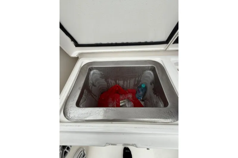  Yacht Photos Pics Stainless steel sink on 2009 Bertram 390 boat with red bag and water bottle.