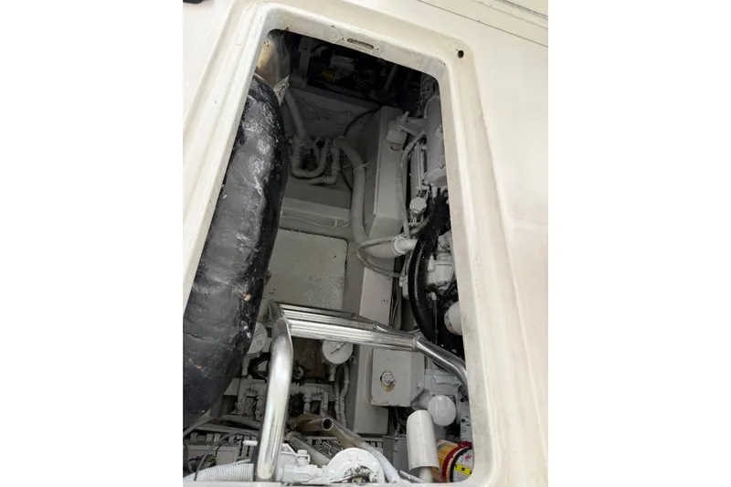  Yacht Photos Pics Engine compartment of a 2009 Bertram 390 boat, showing mechanical components and hoses.