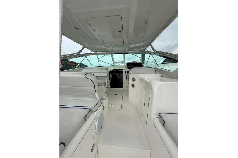 Yacht Photos Pics Interior view of a 2009 Bertram 390 boat, featuring white seating and spacious layout.