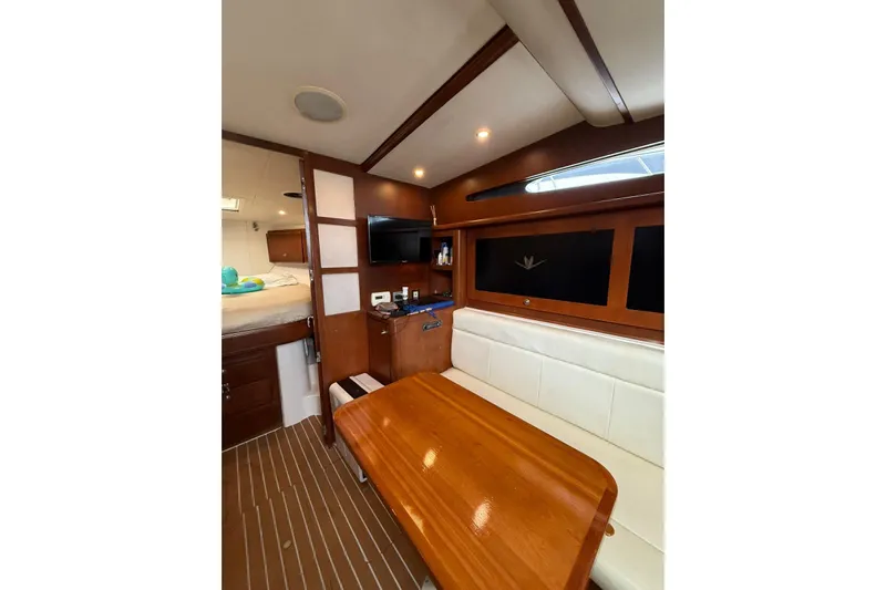  Yacht Photos Pics Interior of 2009 Bertram 390 yacht with wood finishes and seating area.