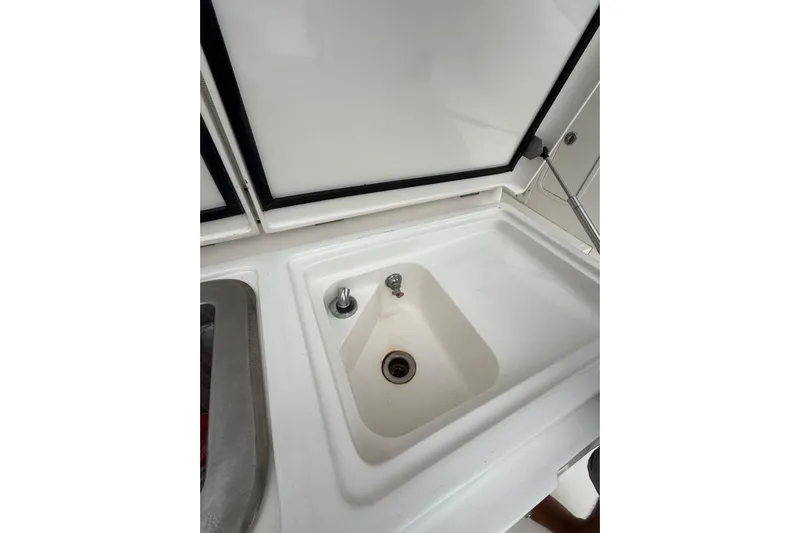  Yacht Photos Pics 2009 Bertram 390 boat sink with faucet and drain, white countertop.
