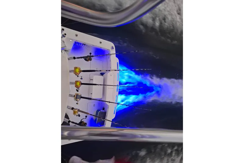  Yacht Photos Pics 2009 Bertram 390 boat with fishing rods and vibrant blue underwater lights.