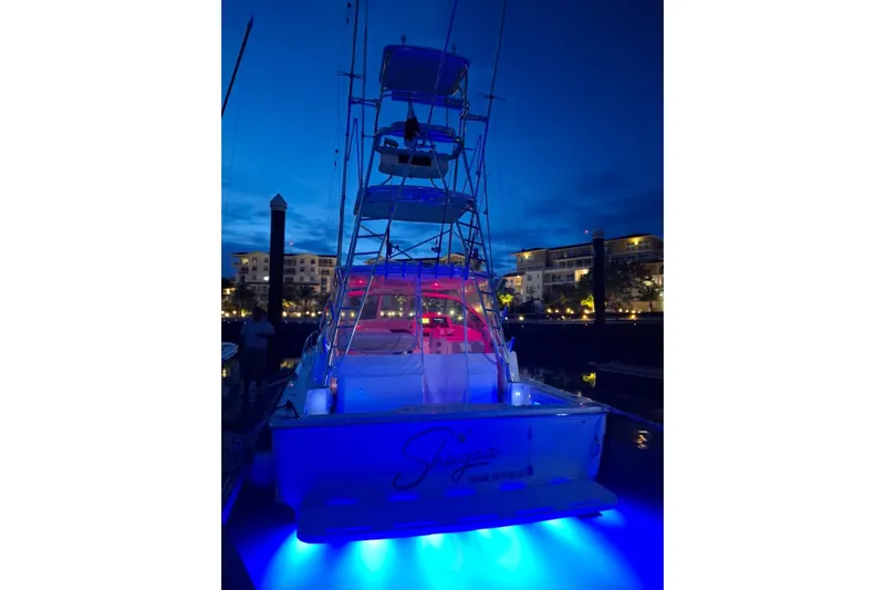  Yacht Photos Pics 2009 Bertram 390 yacht with blue underwater lights at night in a marina.