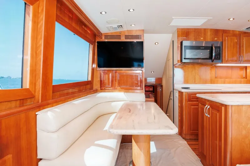 Loca Louise Yacht Photos Pics Luxurious interior of 2002 Hatteras 50 Convertible yacht with wood finishes and modern amenities.