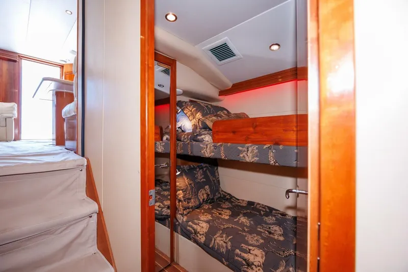 Loca Louise Yacht Photos Pics Interior of 2002 Hatteras 50 Convertible yacht with bunk beds and wooden accents.